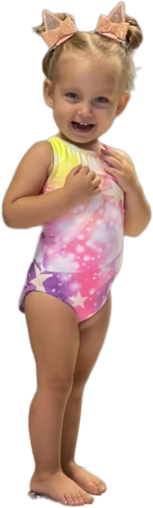 A smiling Bravo Babies toddler in a sparkly rainbow leotard