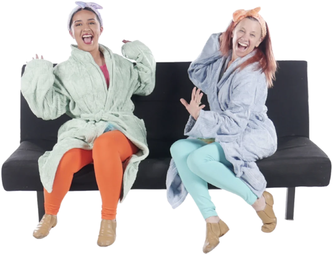 Two adult Encore dancers laughing together