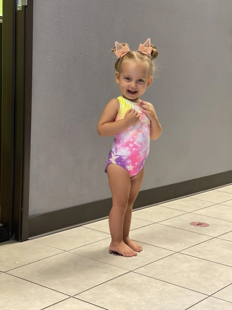 A proud toddler in her first sparkly leotard