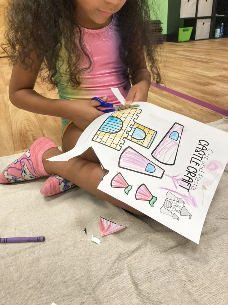 A camper cutting out her castle craft