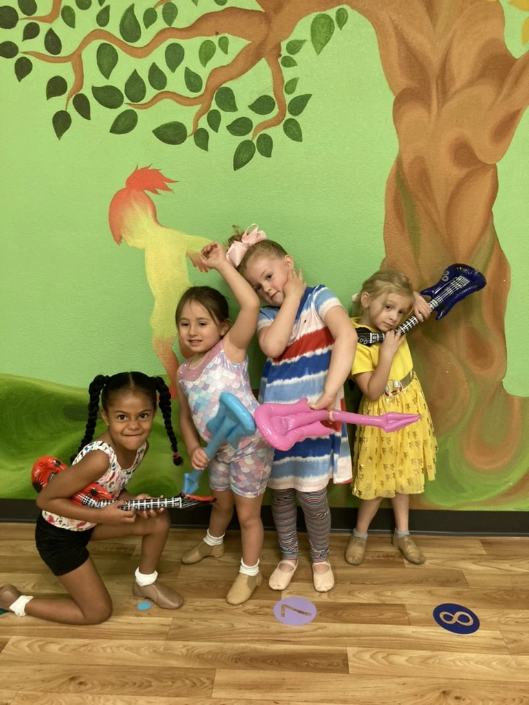Campers posing with inflatable guitars during rock star week