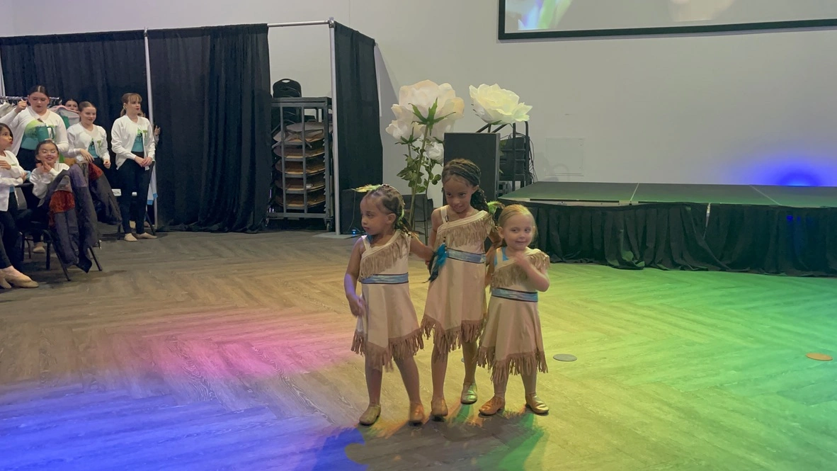 Three mini company dancers in Pocahontas costumes
