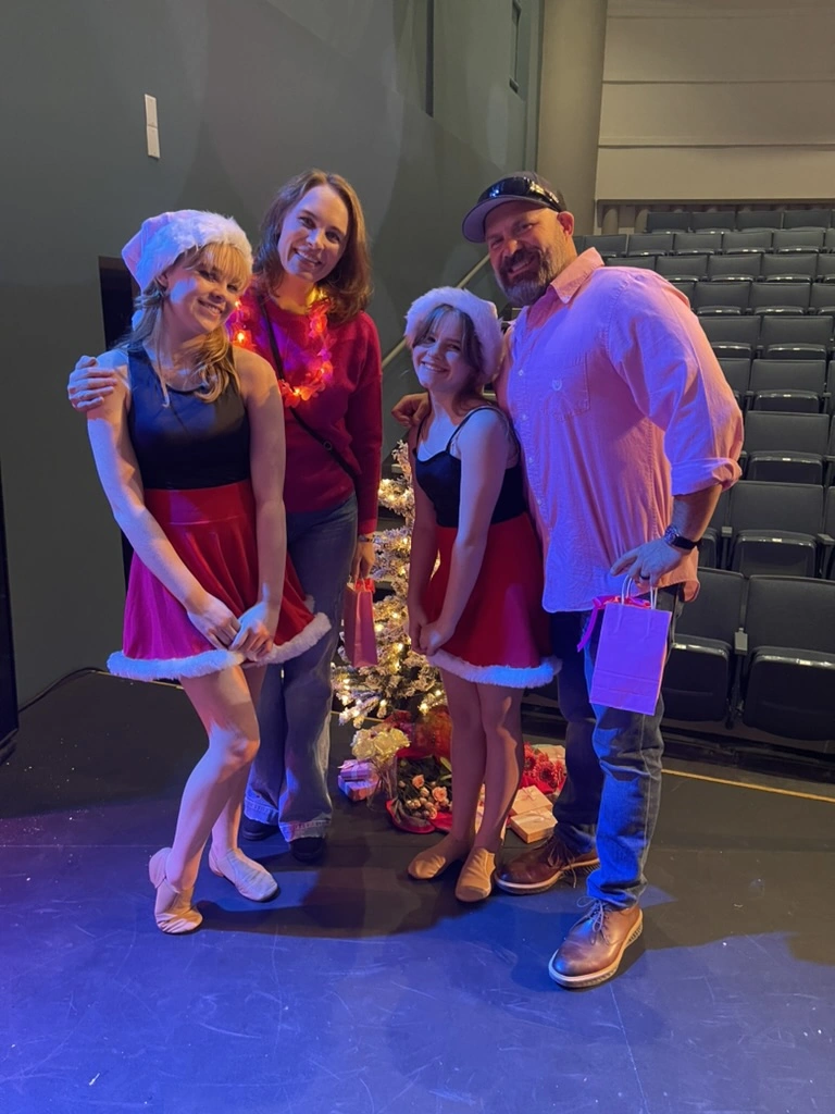 Company dancers with their family after a holiday show