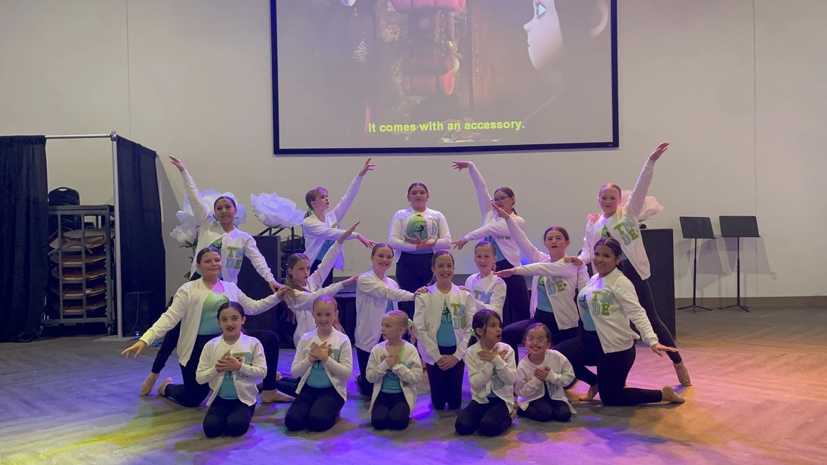 The Movement Dance Company posing together in white TMDE jackets