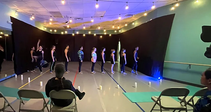 Company dancers in a candlelit studio showcase
