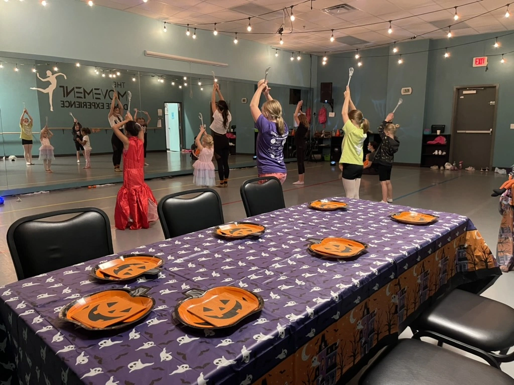 Kids in costumes dancing at a Movement Halloween party