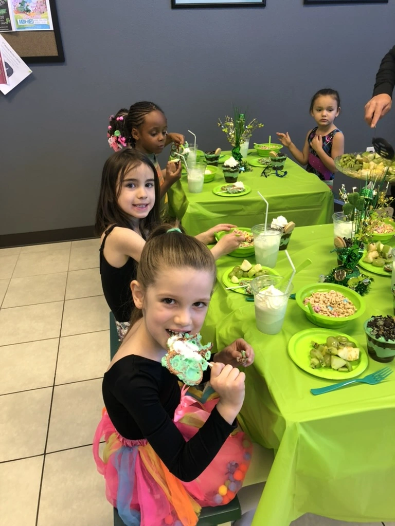 Kids enjoying green treats at a Movement St. Patrick's Day party
