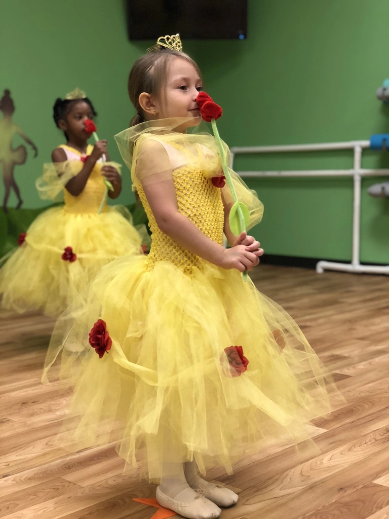 Little Belles in yellow tutus smelling their roses in Once Upon a Ballet