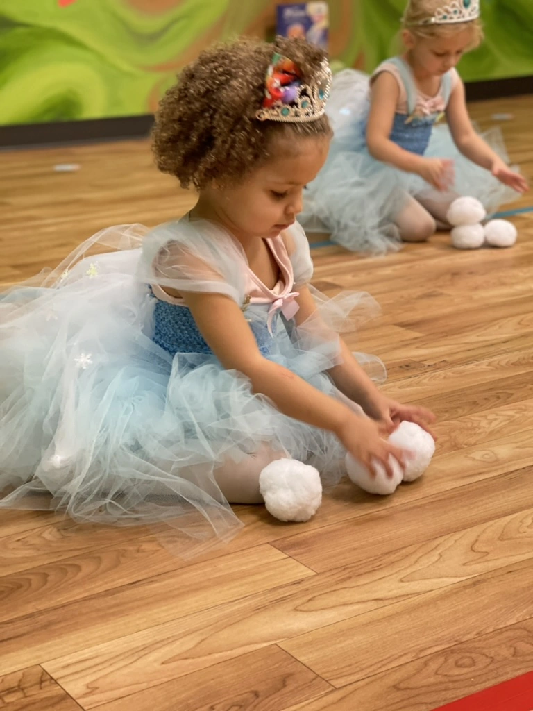 A little snow princess playing with snowballs in Once Upon a Ballet