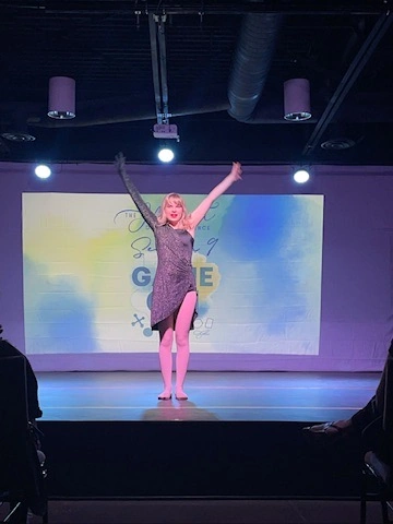 A dancer in sparkles taking her bow at Ovation Theatre
