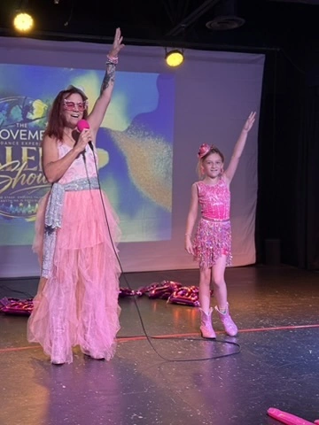 The emcee and a young performer celebrating at The Movement Talent Show