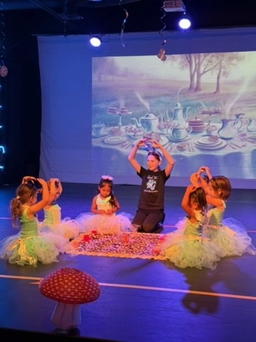 Little dancers in green tutus at a story ballet tea party in Ovation Theatre